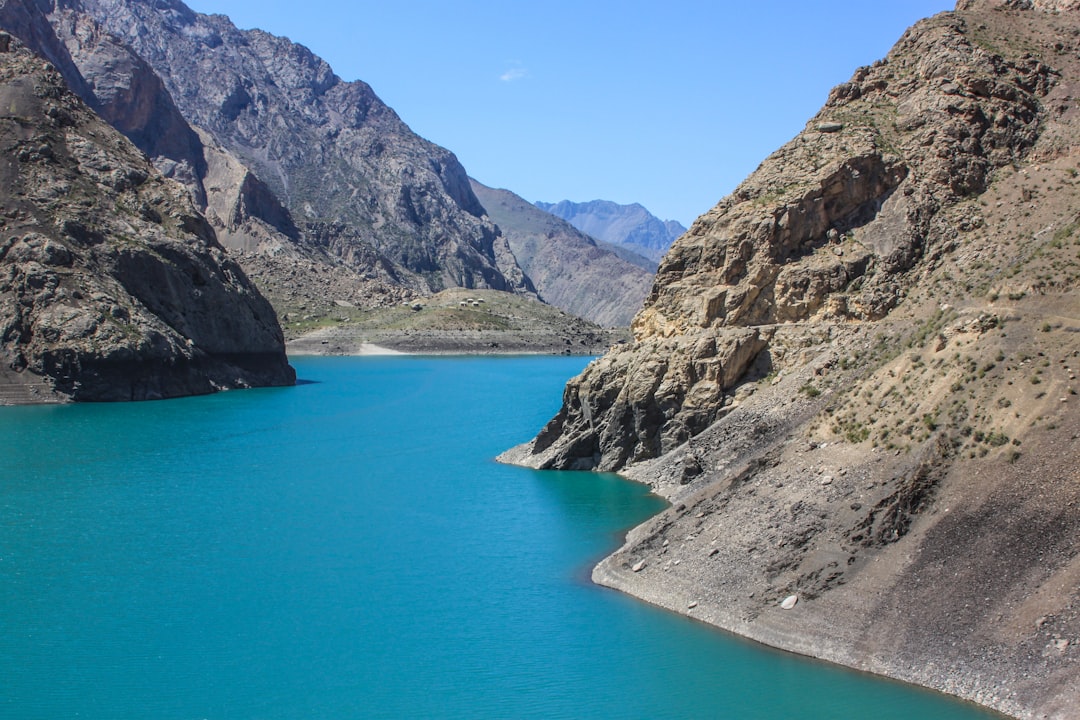 a large body of water surrounded by mountains, Clean blue lake