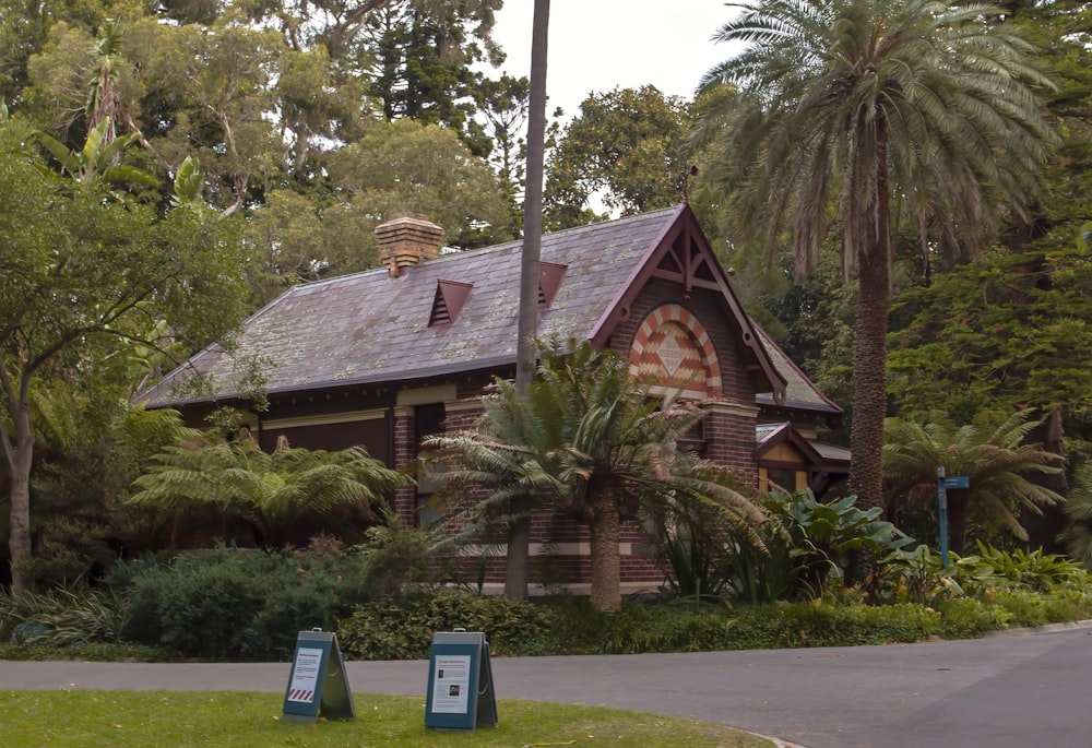 a small wooden building surrounded by trees and bushes