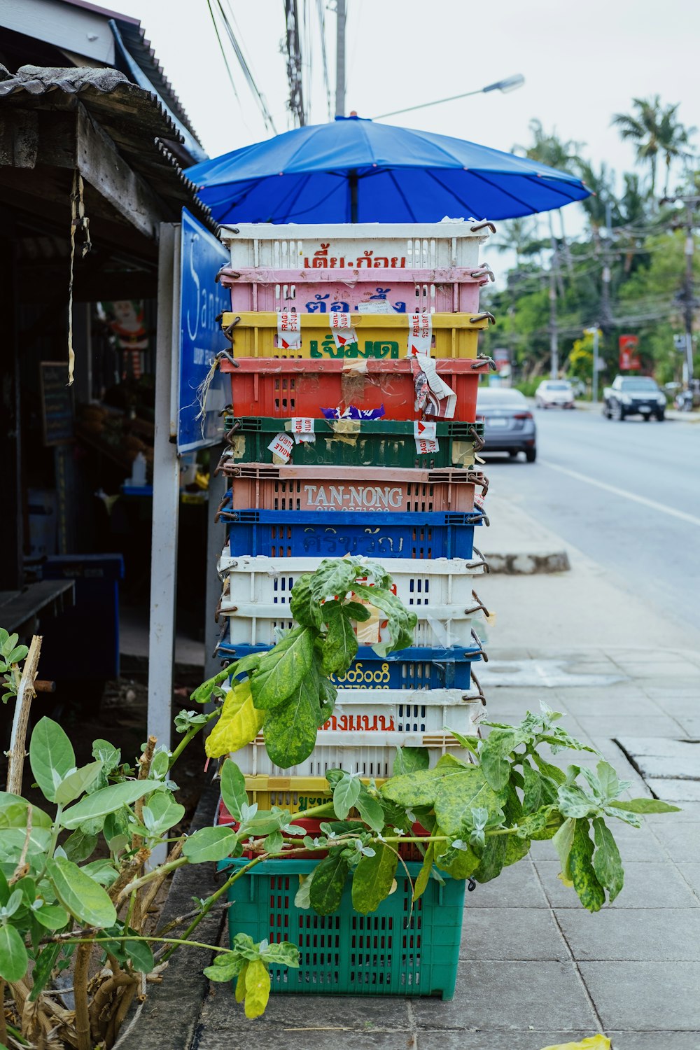 a stack of crates sitting on the side of a road