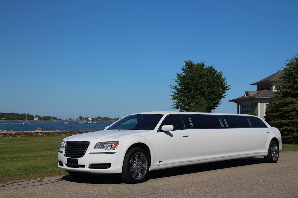 a white limo parked on the side of the road