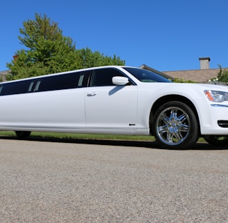 a white limo parked on the side of a road