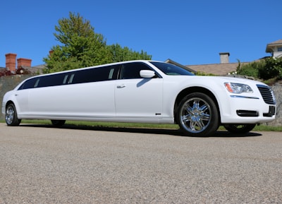 a white limo parked on the side of a road