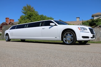 a white limo parked on the side of a road