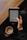 A person is holding an e-reader device in one hand, reading text on the screen, while also holding a mug of coffee in the other hand. The setting appears cozy with a wooden table in the background and the person wearing a dark-colored outfit.