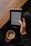 A person is holding an e-reader device in one hand, reading text on the screen, while also holding a mug of coffee in the other hand. The setting appears cozy with a wooden table in the background and the person wearing a dark-colored outfit.