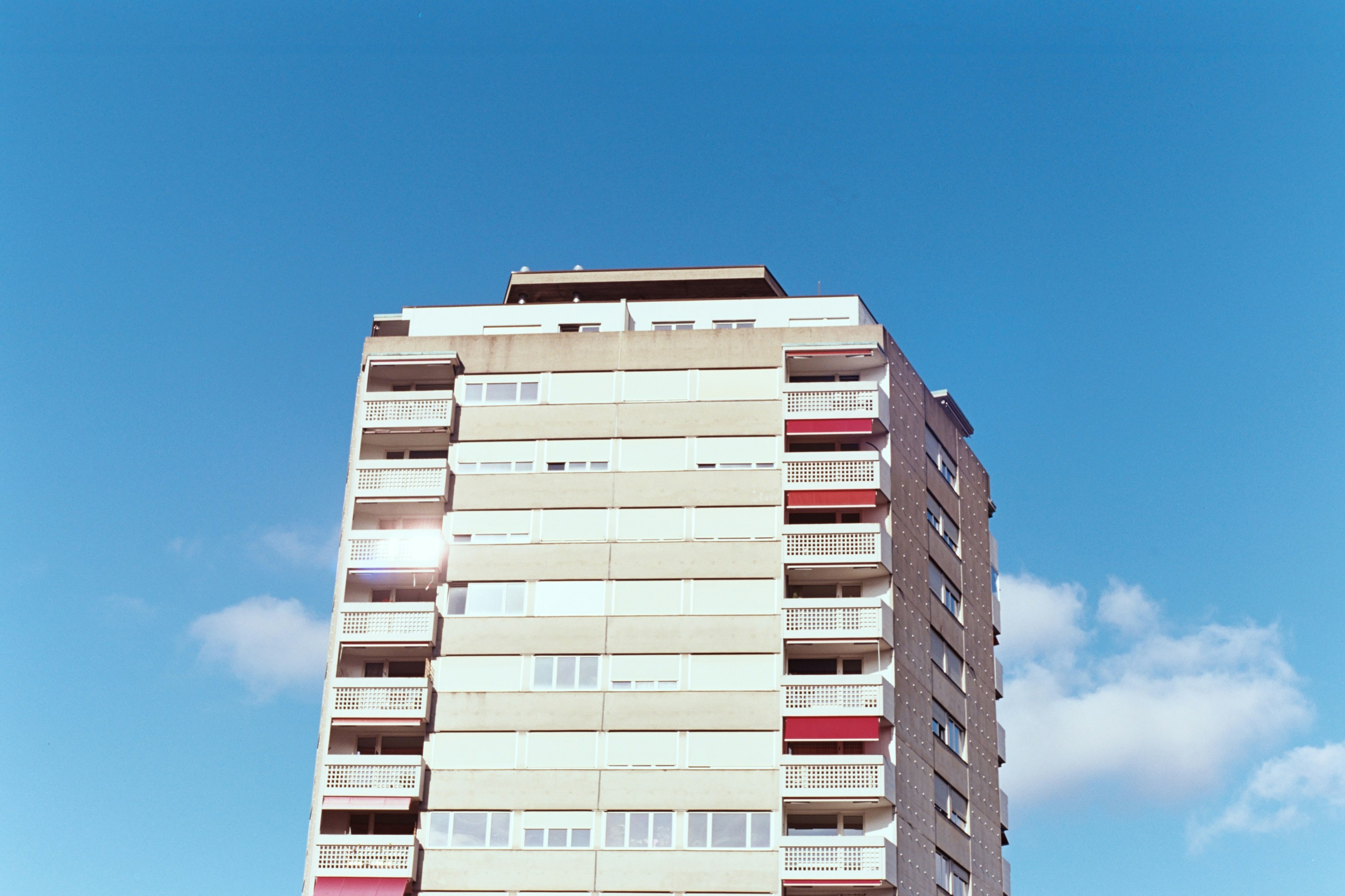A modern apartment building with a dedicated pet relief area and a sign indicating pet-friendly policies - animal friendly apartments for rent