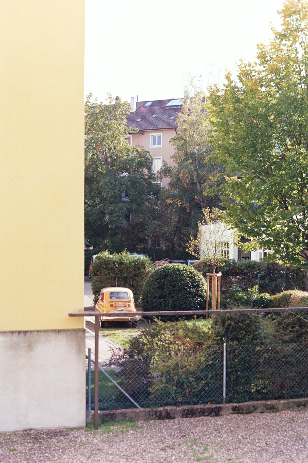 a yellow van parked in front of a tall building