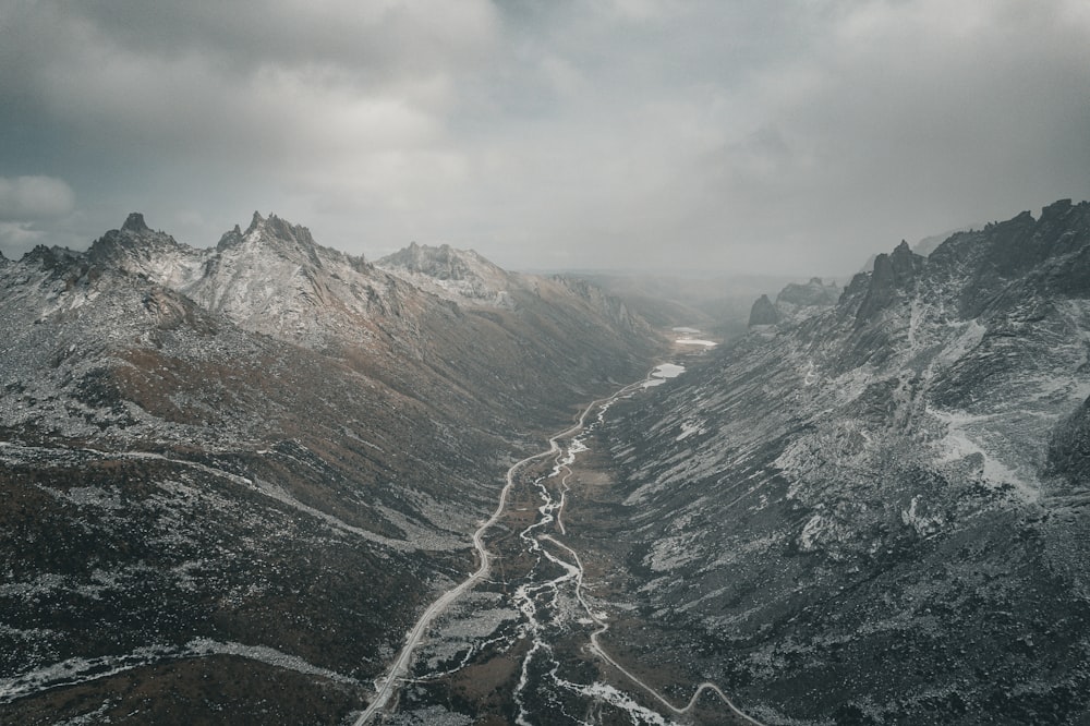 a view of a snowy mountain range from the top of a mountain