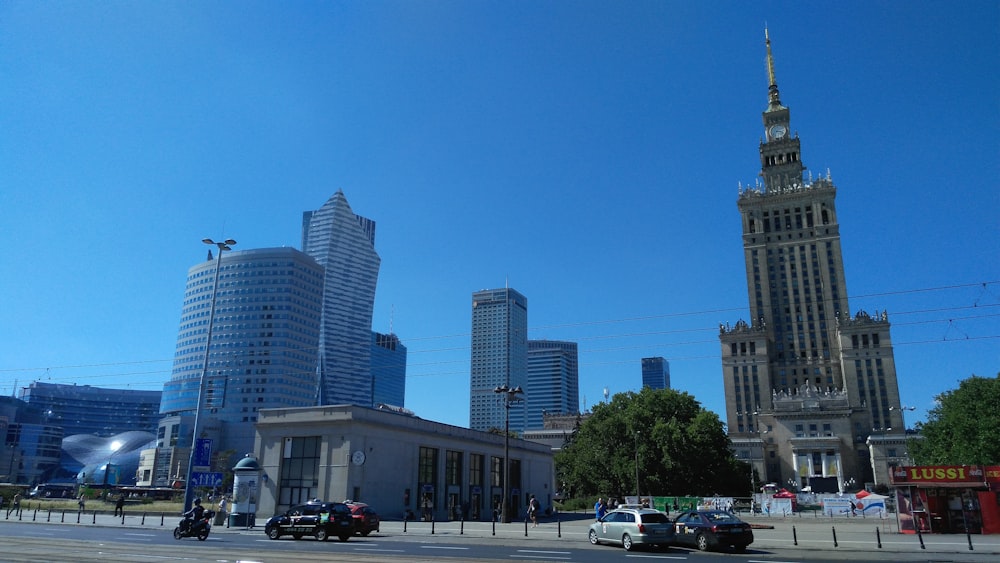 a city street with tall buildings in the background