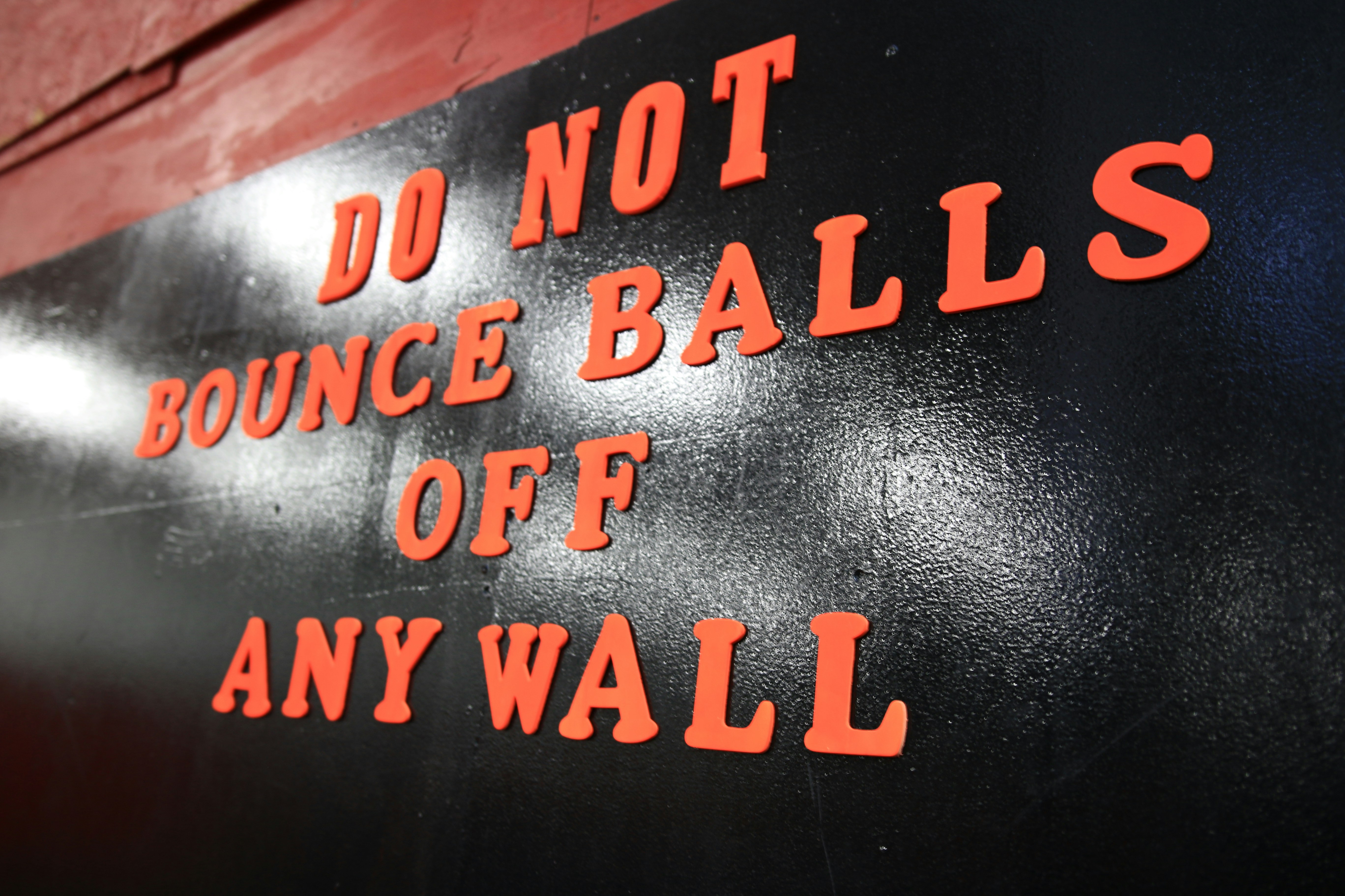 a sign that says do not bounce balls off any wall