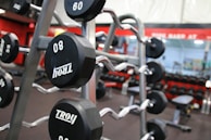 a gym filled with black and silver dumbs