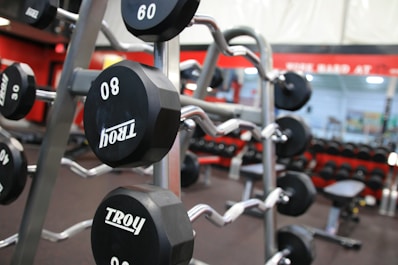 a gym filled with black and silver dumbs