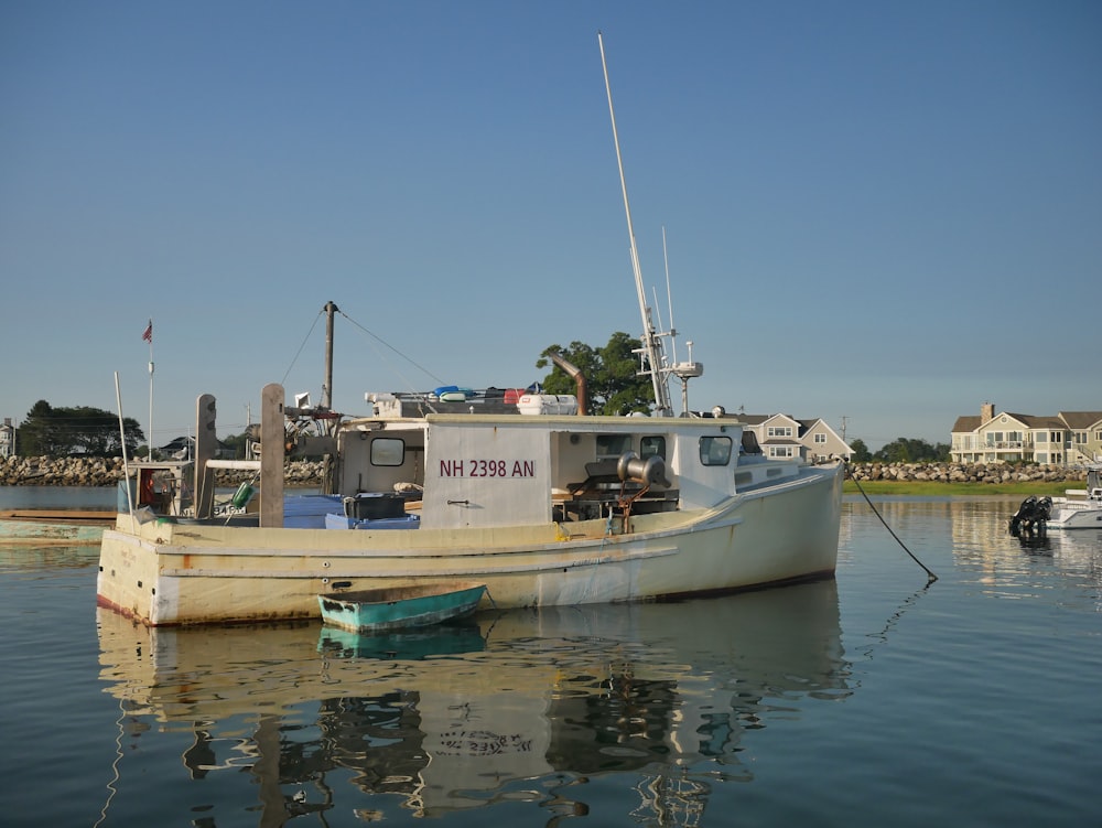 a small boat sitting in the middle of a body of water