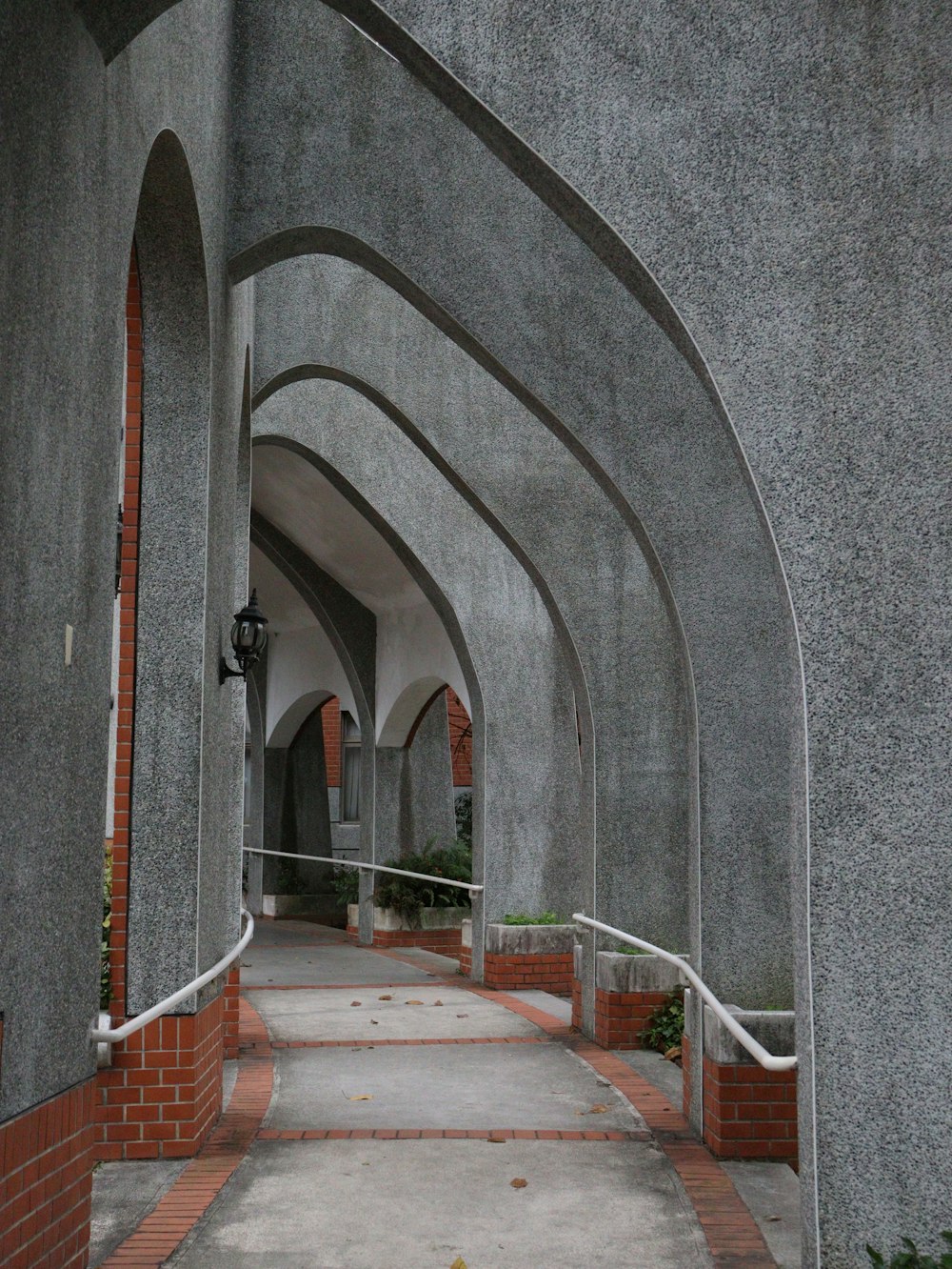 a walkway with a clock on the side of it