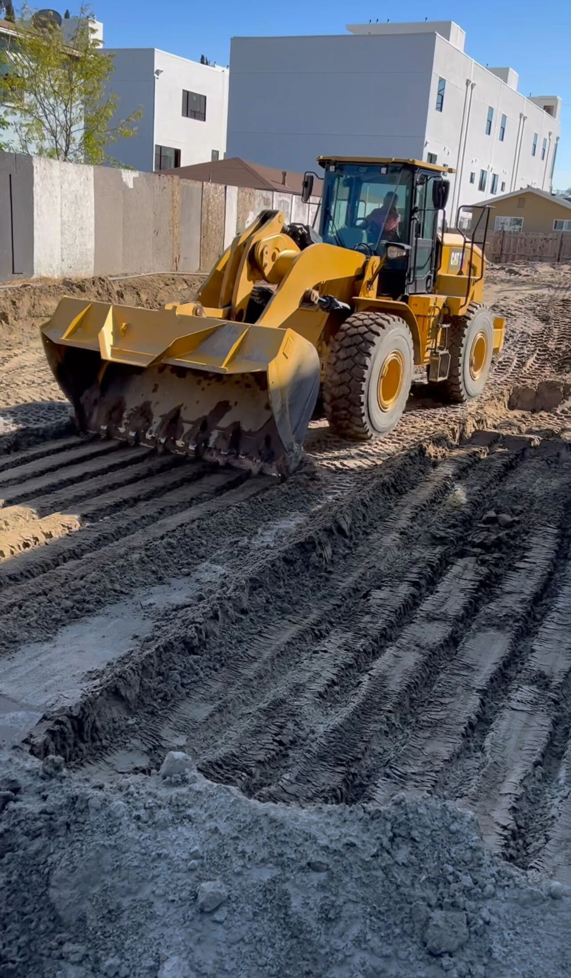 a large yellow bulldozer sitting on top of a dirt field