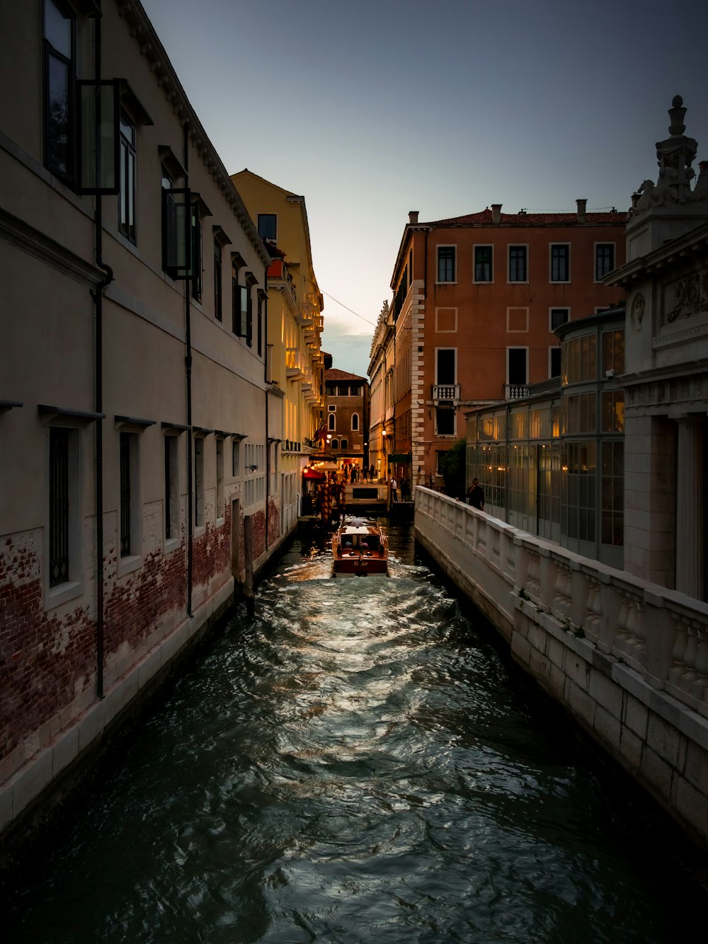 a boat is going down a narrow canal