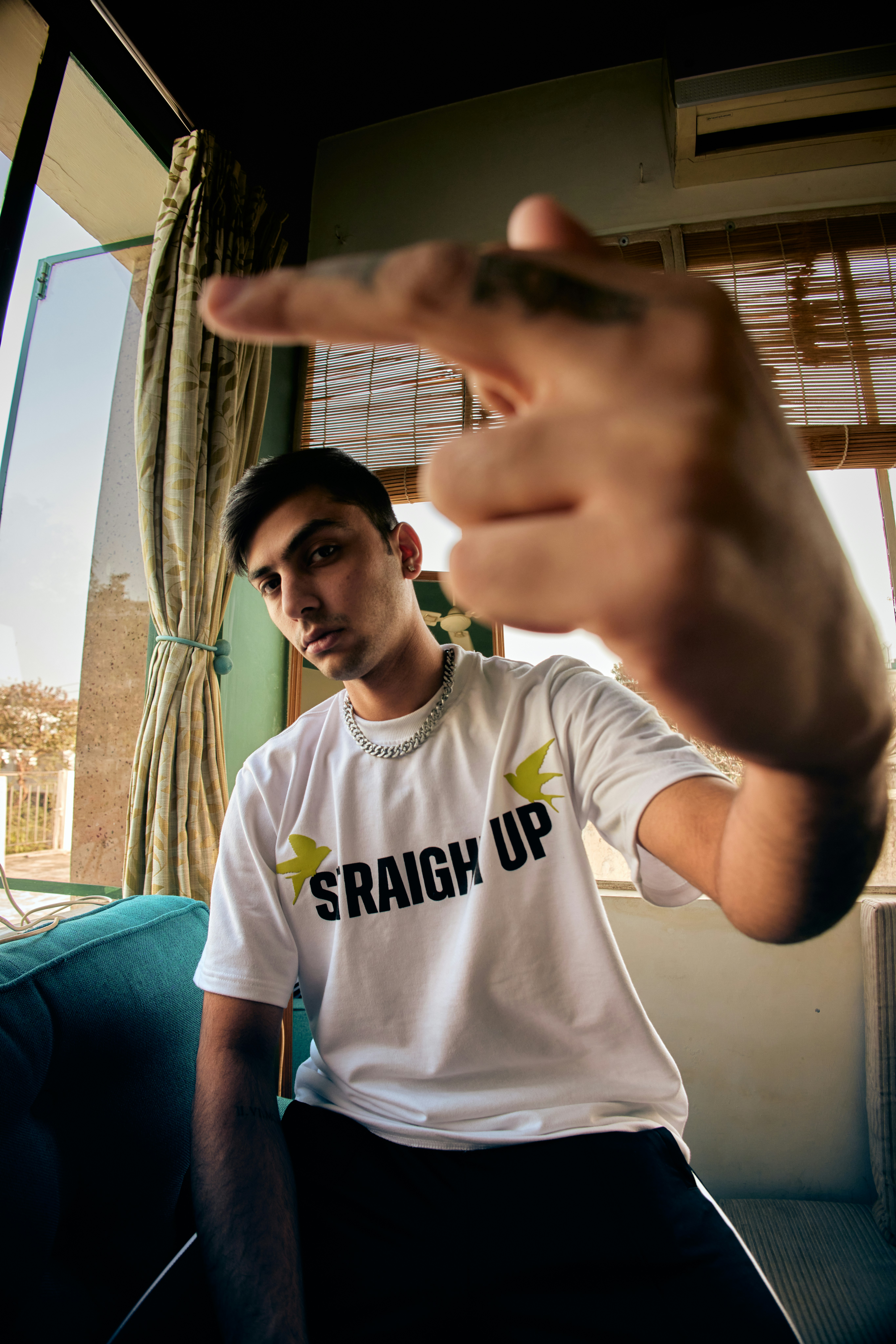 a man sitting on a couch pointing at something