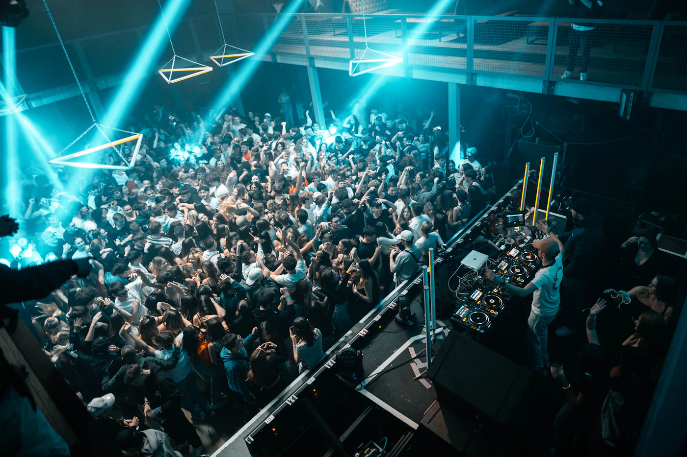 Guests enjoying DJ entertainment in a colorful venue