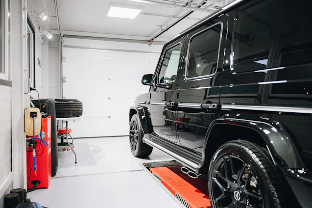 A sleek, modern car being expertly serviced in a clean, well-lit garage.