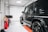 A gleaming car with a flawless finish parked in a well-lit garage.
