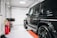 A gleaming car with a flawless finish parked in a well-lit garage.
