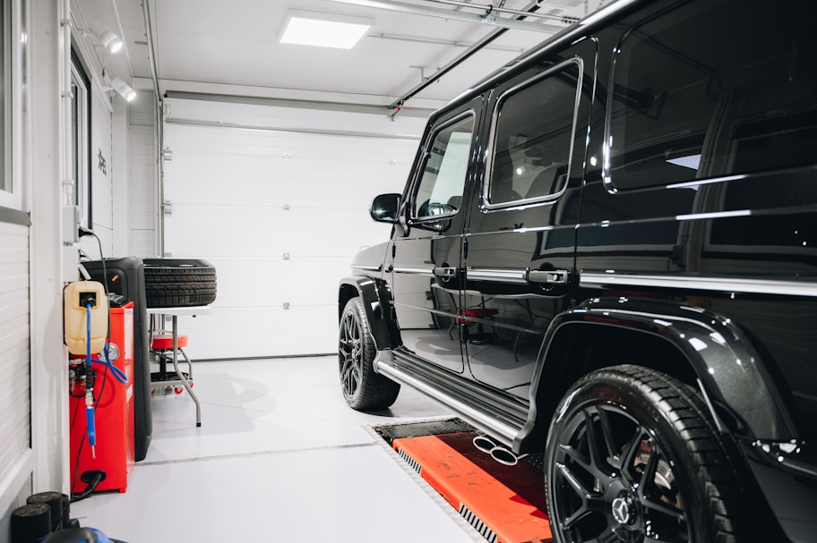 a black jeep is parked in a garage