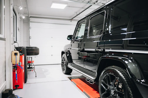 a black jeep is parked in a garage
