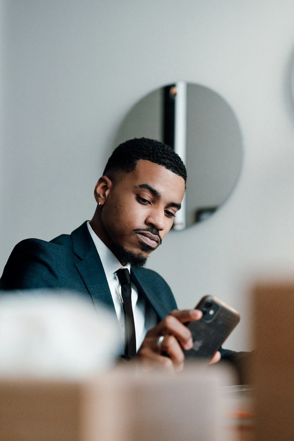 a man in a suit looking at his cell phone