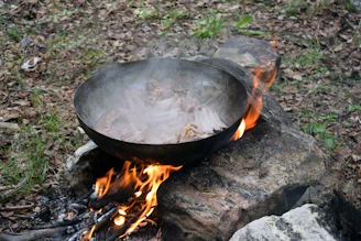 Chef carefully placing local ingredients into a geothermal cooking pit.