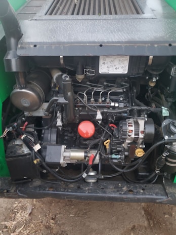 Close-up of diagnostic tools connected to a hybrid electric vehicle's engine compartment.