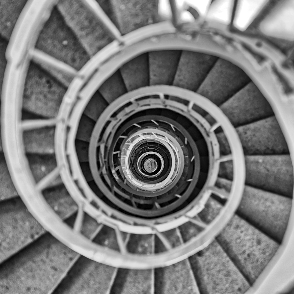 a black and white photo of a spiral staircase