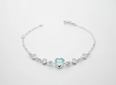 a silver bracelet with a heart on it