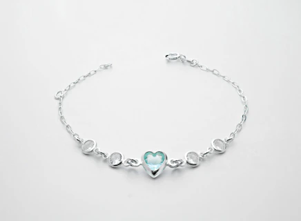 a silver bracelet with a heart on it
