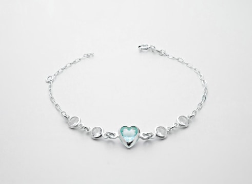 A delicate silver bracelet with charms.