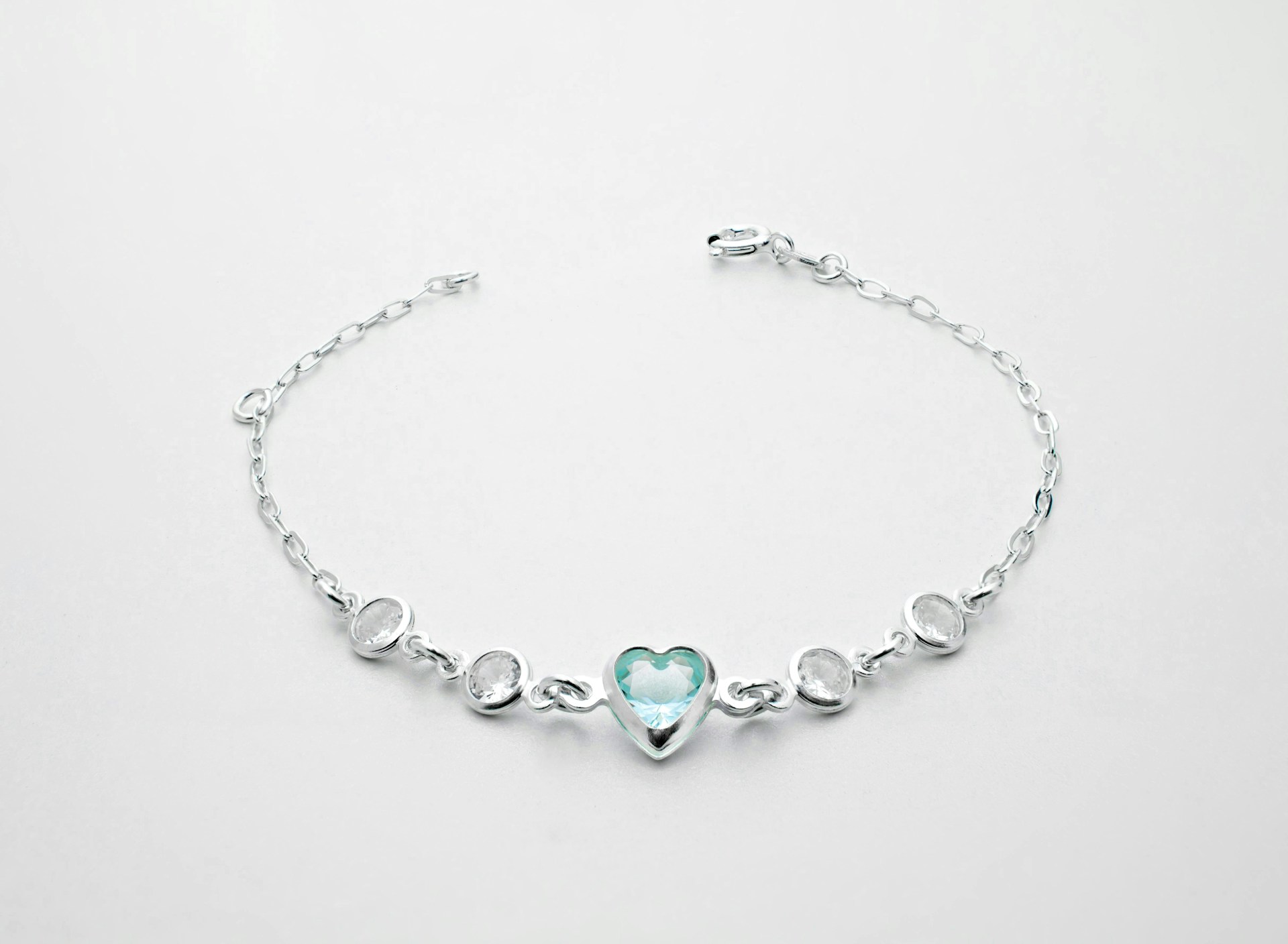 a silver bracelet with a heart on it