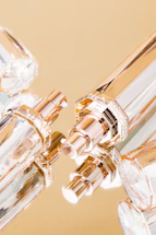 Elegant close-up of a luxury perfume bottle with soft gold accents on a white background.