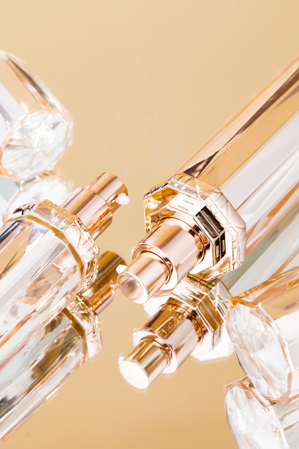 Elegant Arabian perfume bottles arranged on a velvet cloth with warm ambient light.