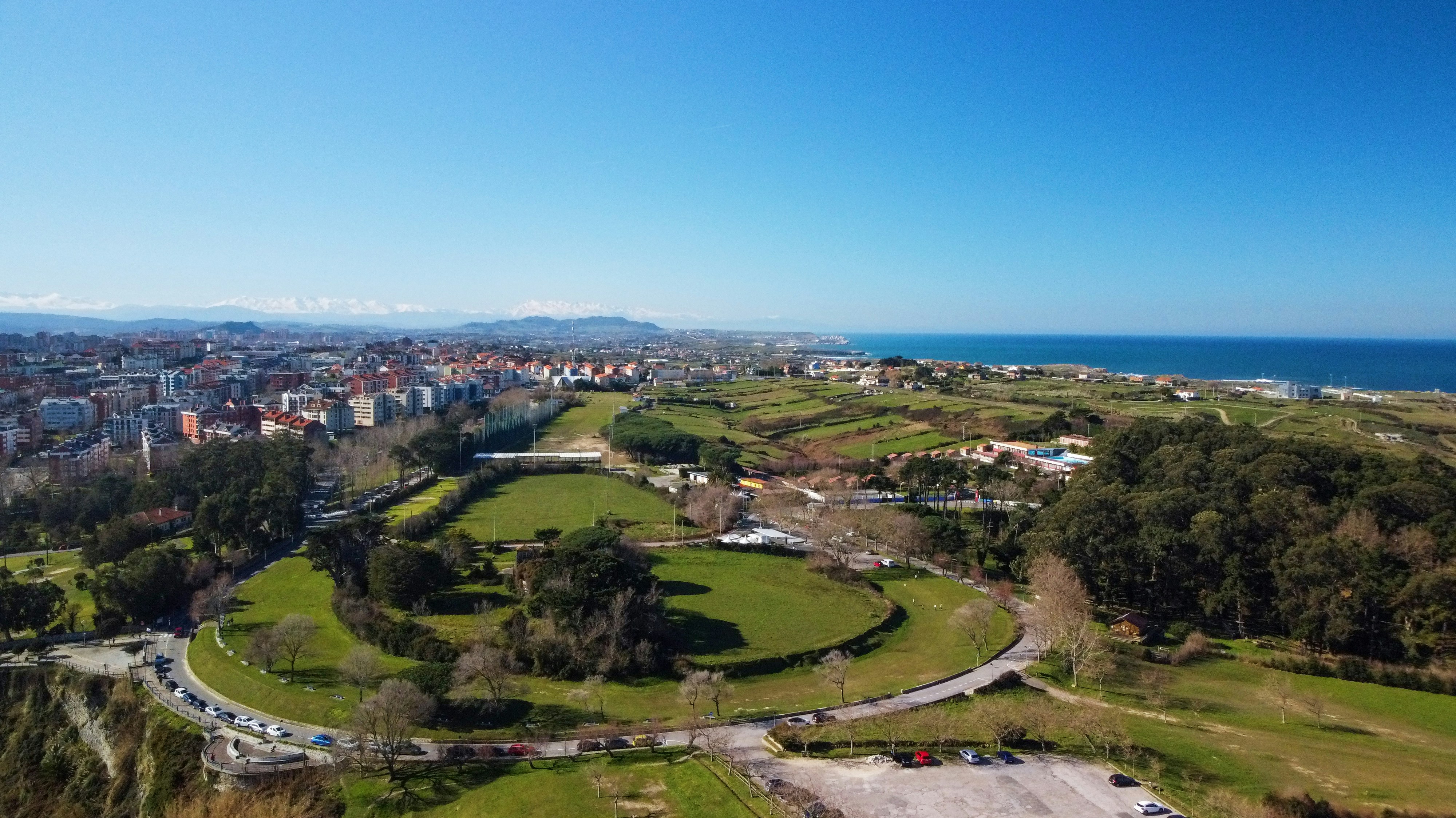 an aerial view of a city and the ocean