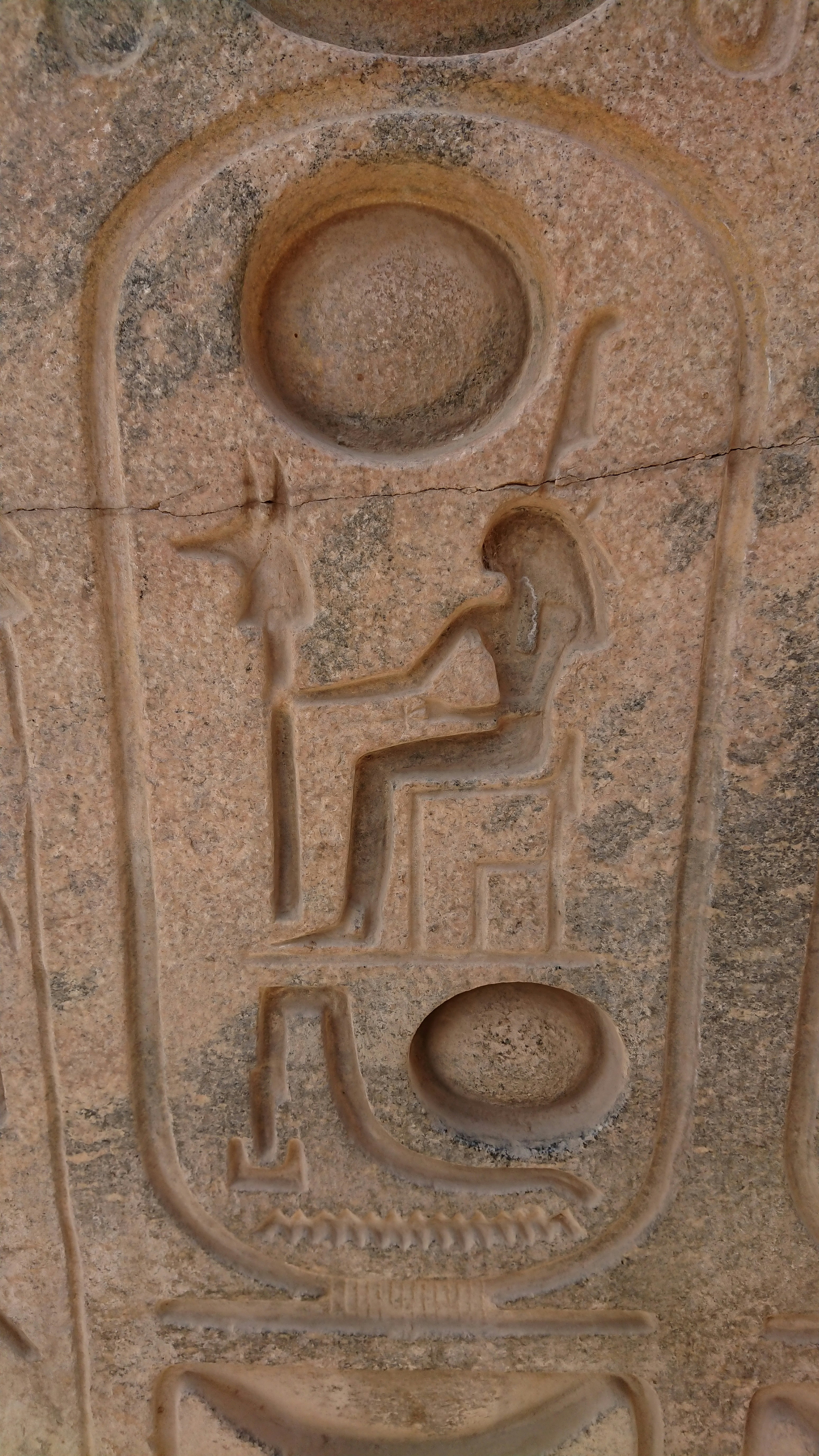 Ancient Egyptian carved stone palette with hieroglyphic reliefs depicting pharaoh Narmer, dark grey stone