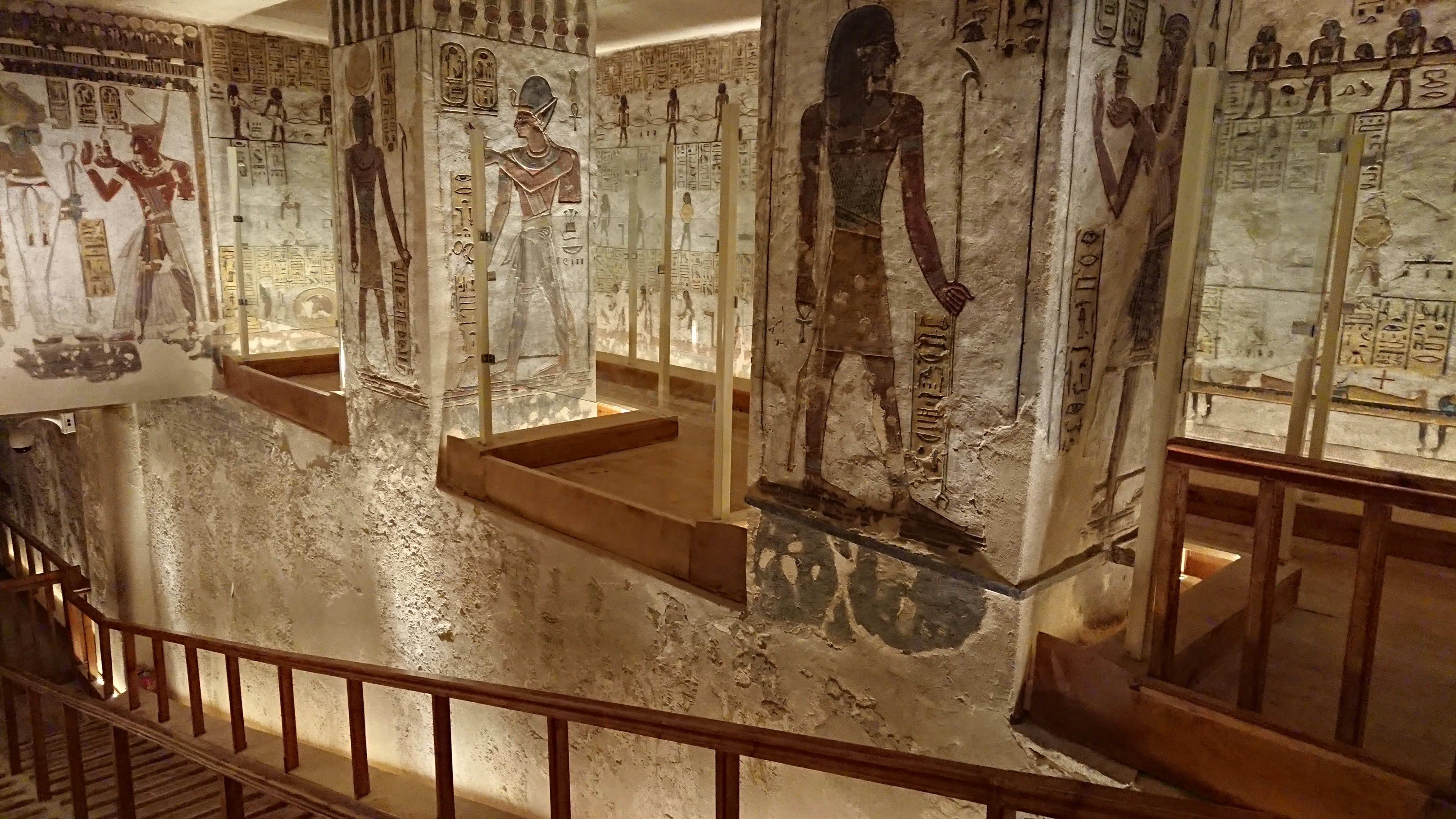 Ancient Egyptian tomb wall paintings showing people playing board games, hieroglyphs, warm earth tones
