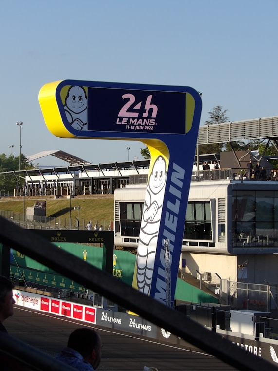 a blue and yellow sign with a cartoon character on it