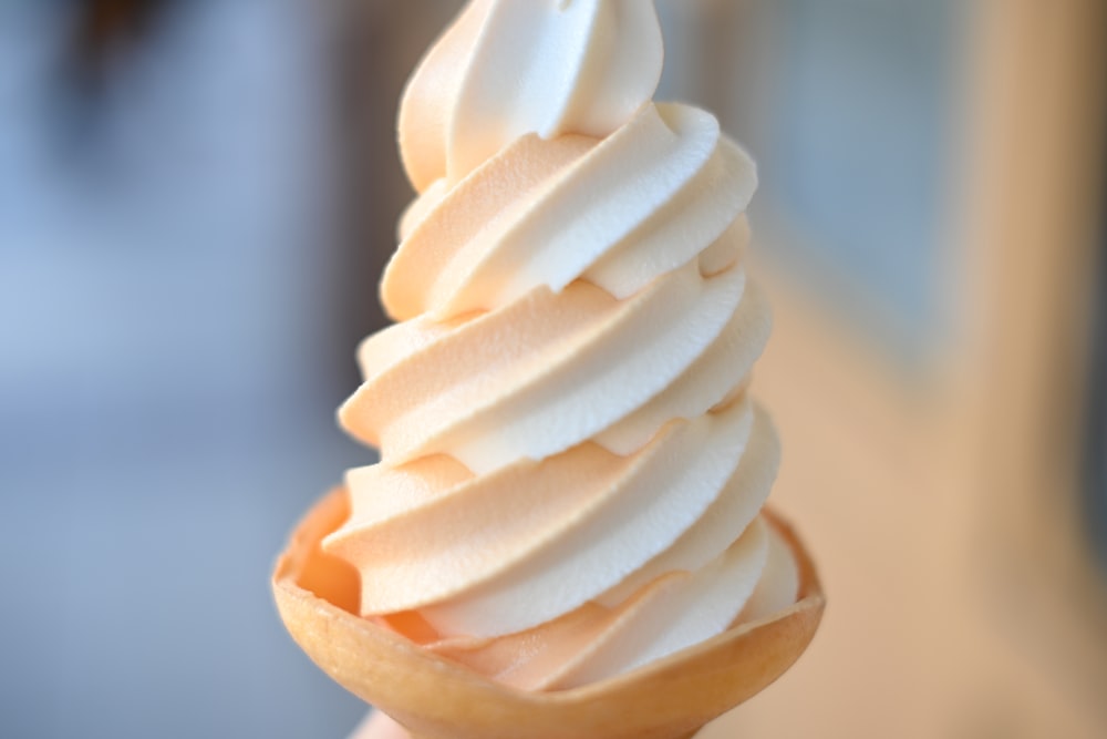 a close up of a person holding a cup of ice cream
