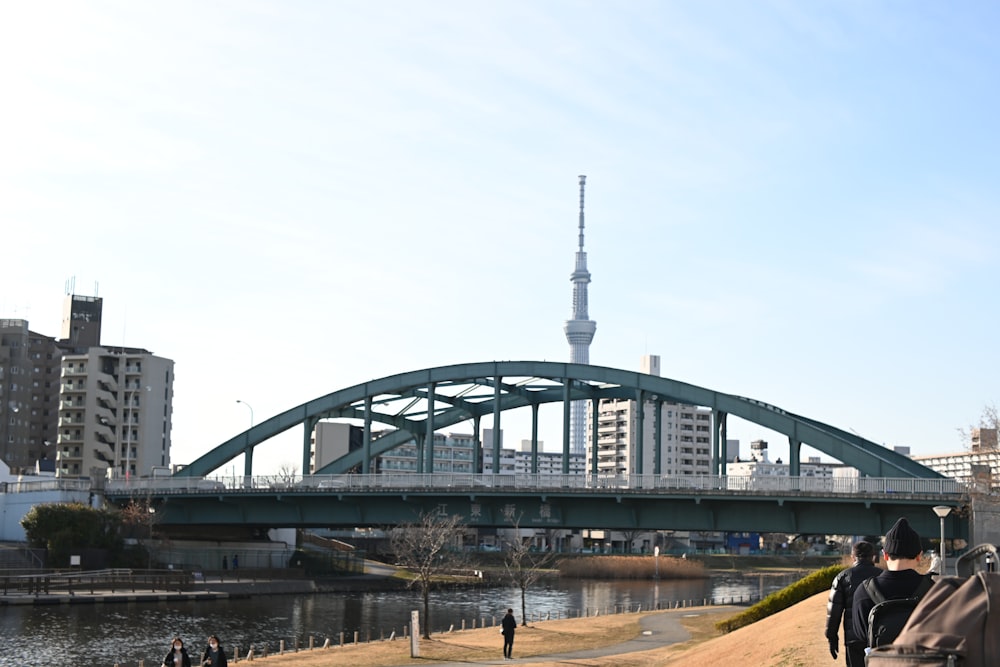 a bridge over a river with people walking on it