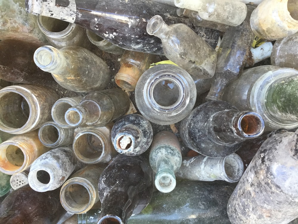 a pile of old glass bottles sitting next to each other