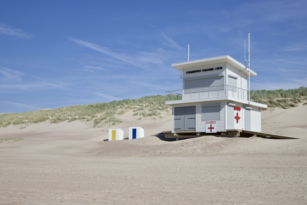 a lifeguard tower sitting on top of a sandy beach