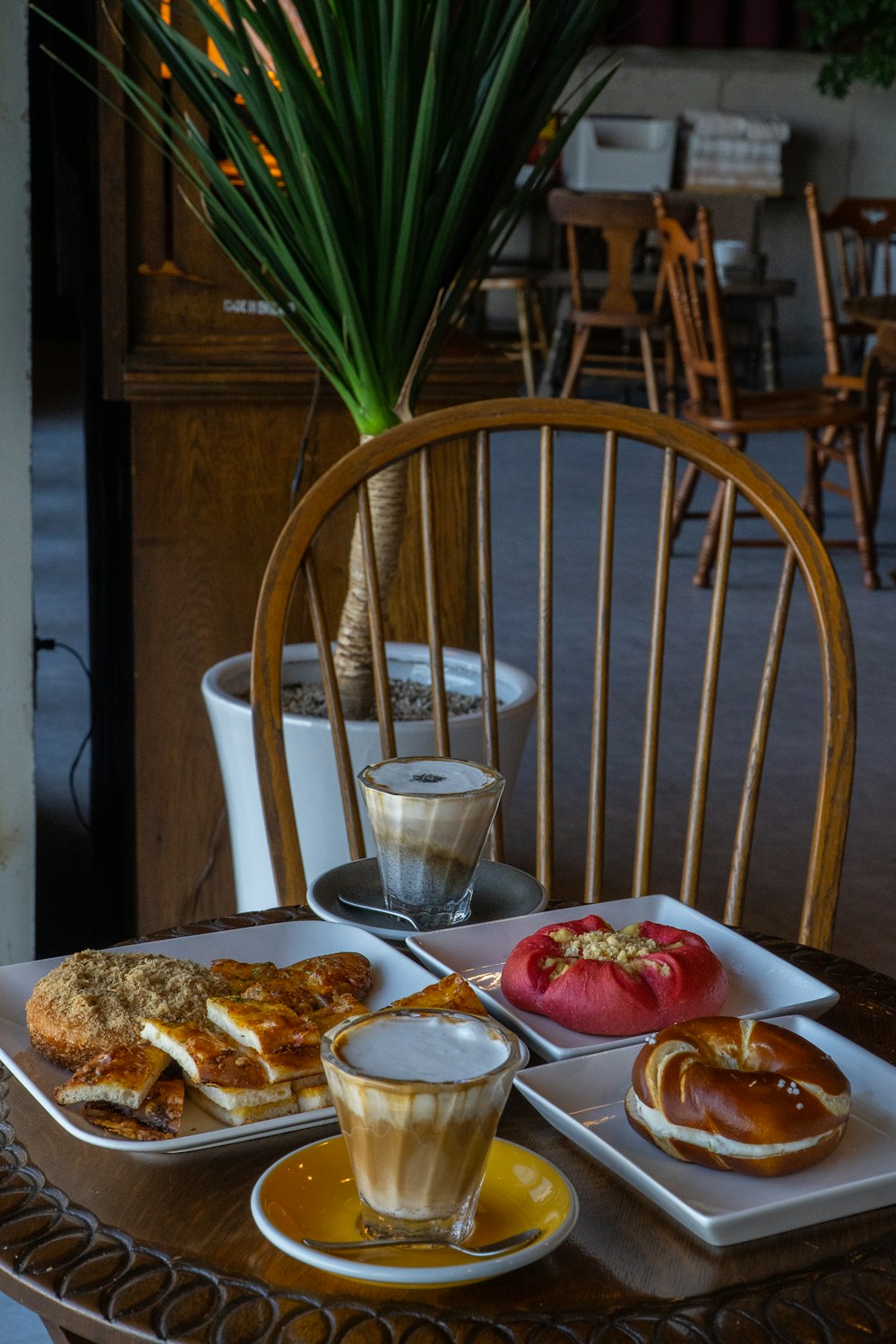 a table topped with plates of food and a cup of coffee