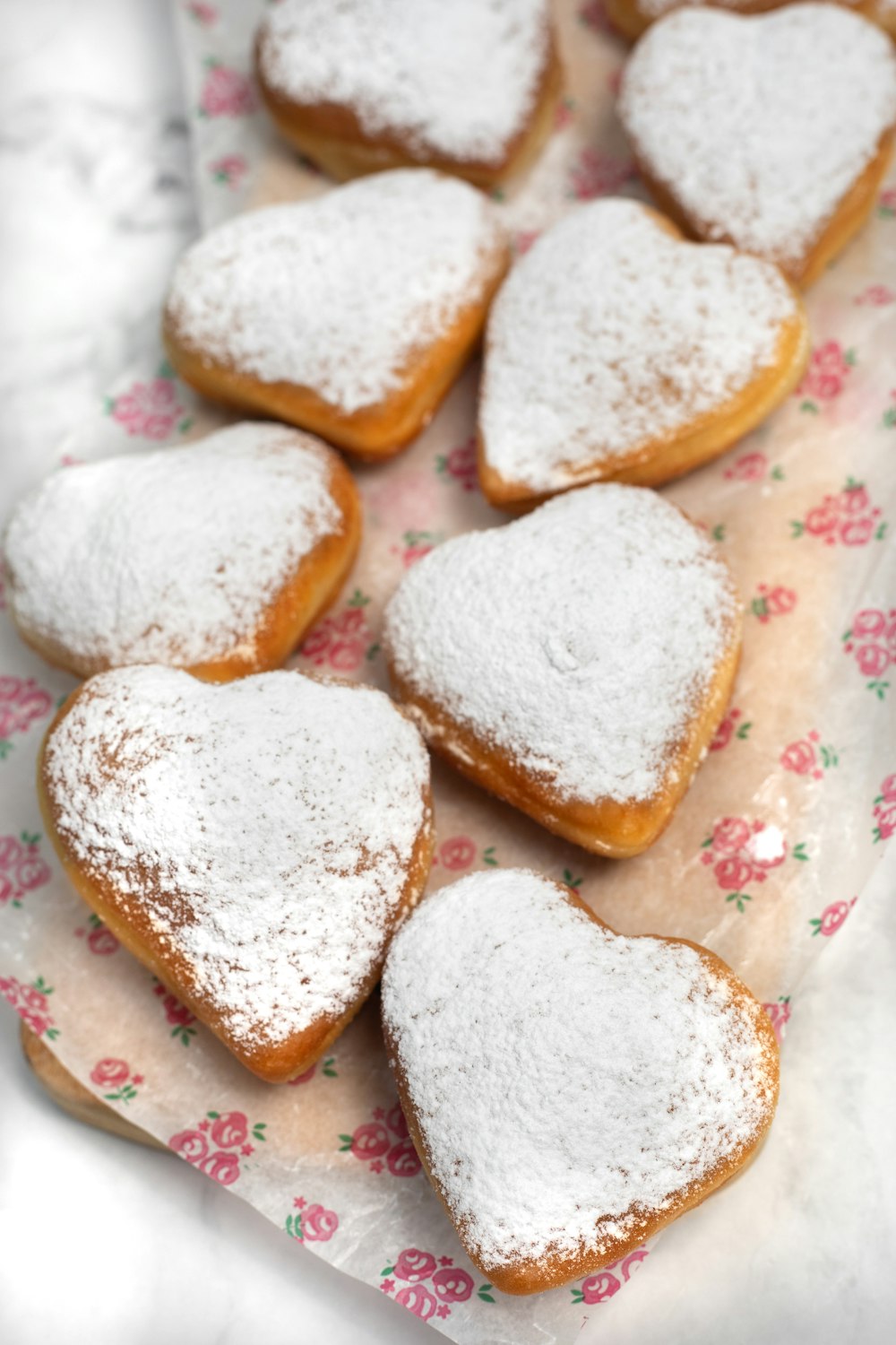 a bunch of heart shaped pastries on a table