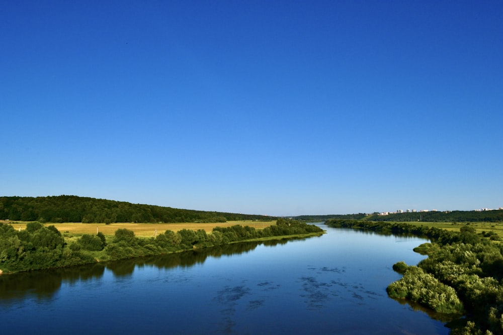 a river running through a lush green countryside