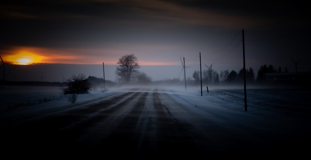 a road that is covered in snow at night