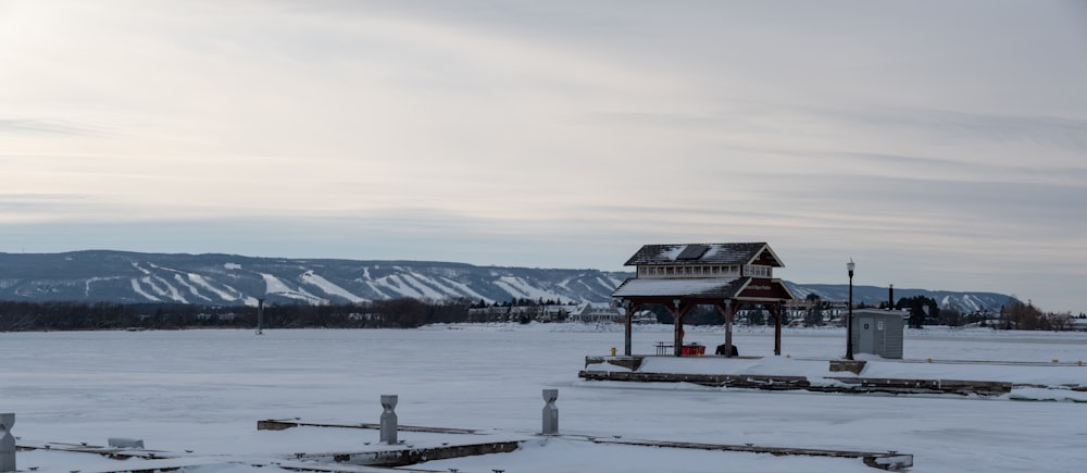 a gazebo in the middle of a snowy field